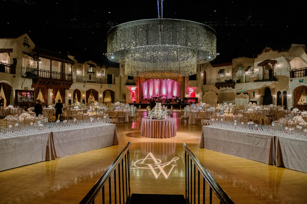 Large chandelier above wedding cake at Indiana Roof Ballroom.