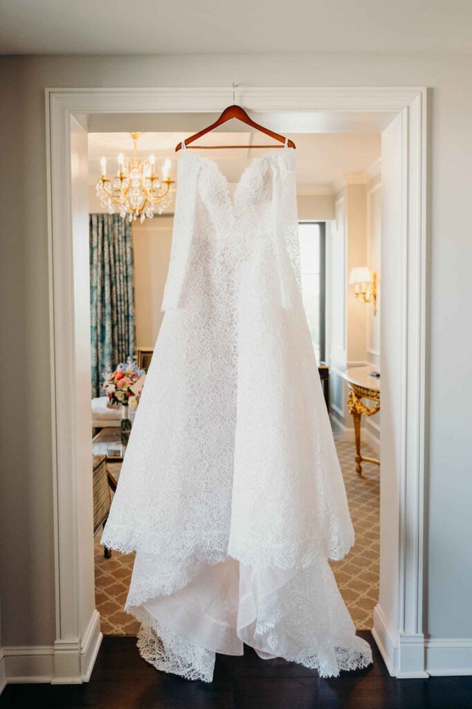 Bride dress hanging on door frame in Hotel Carmichael Bridal Suit Carmel, Indiana