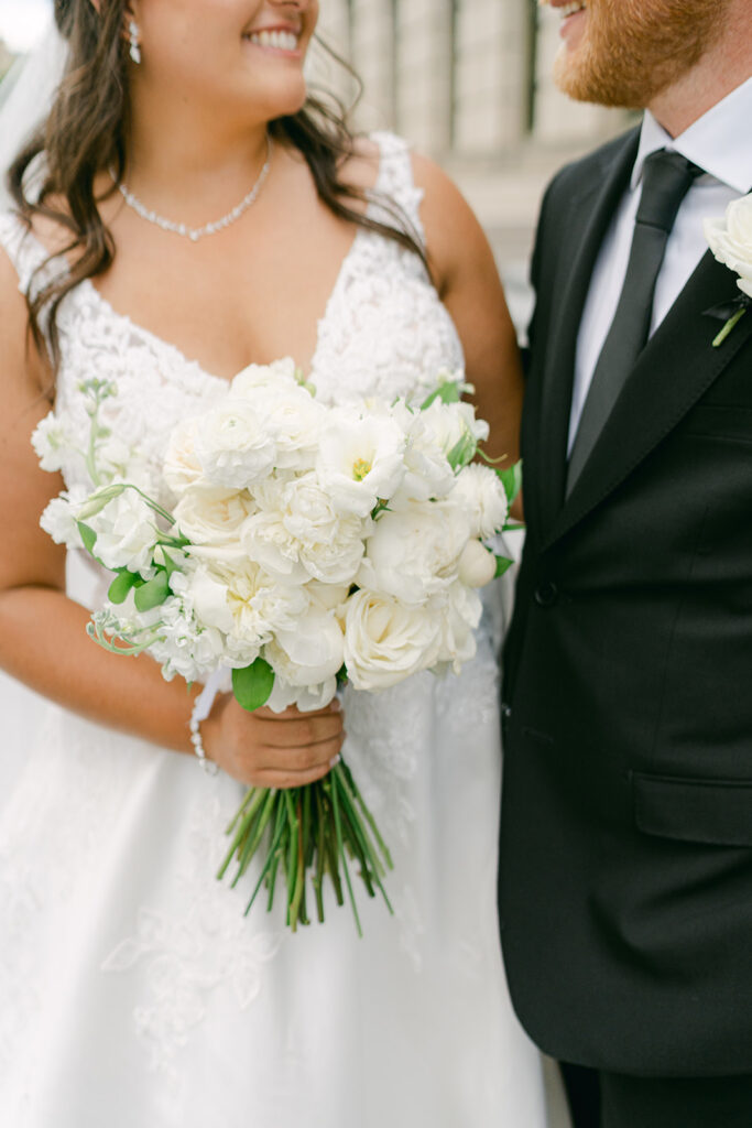 Bride holding beautiful wedding florals.