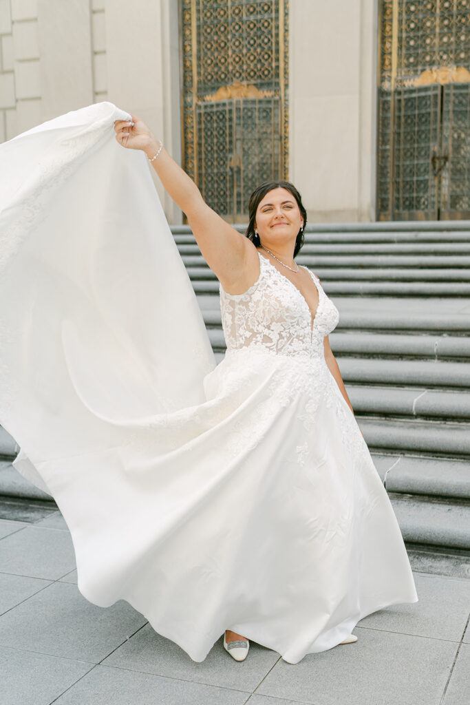 War memorial wedding bride playing with dress.