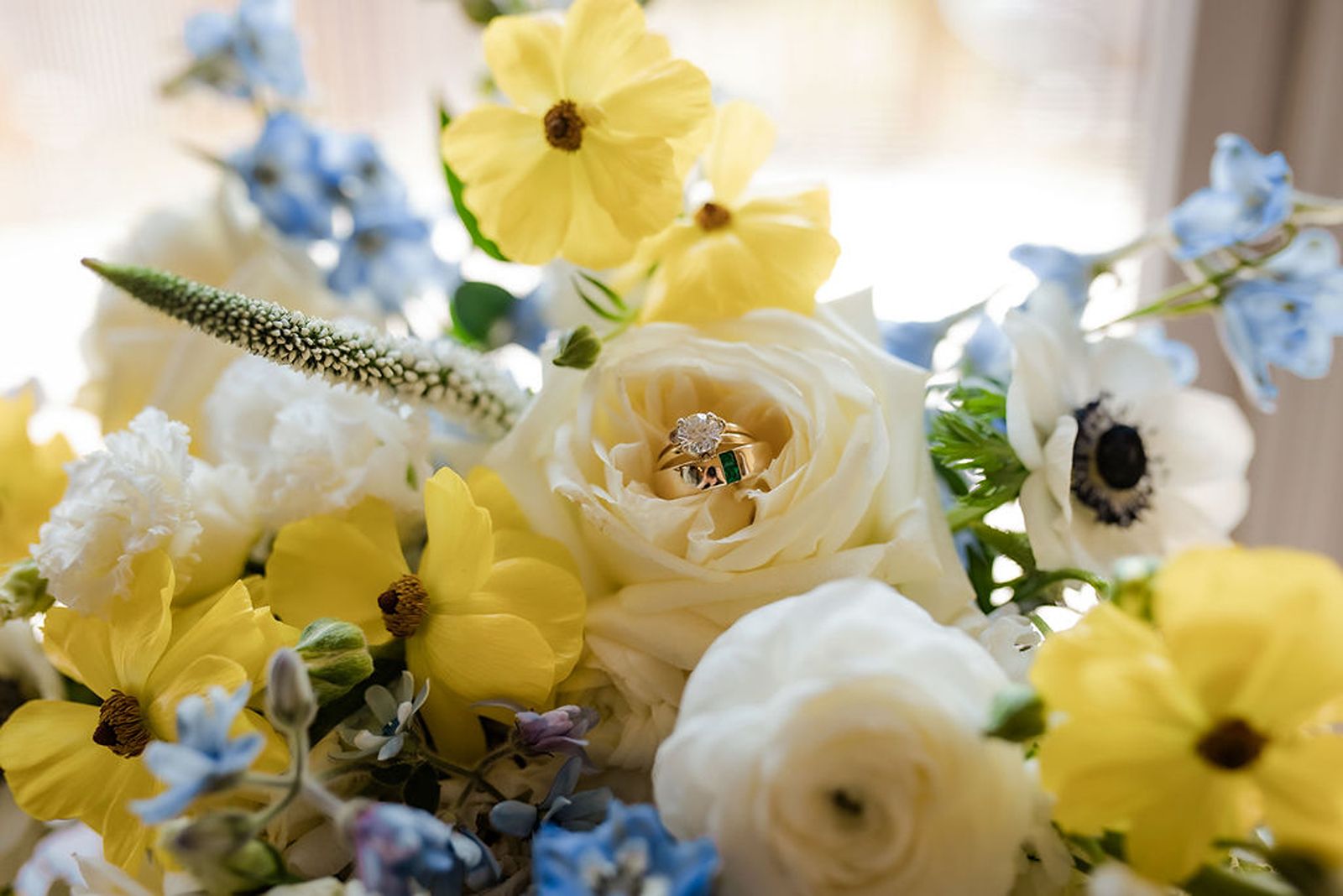 Bridal rings in a beautiful boque of flowers.