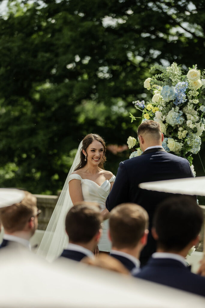 Groom reading vows to his bride during the ceremony at newfields, brides reaction.