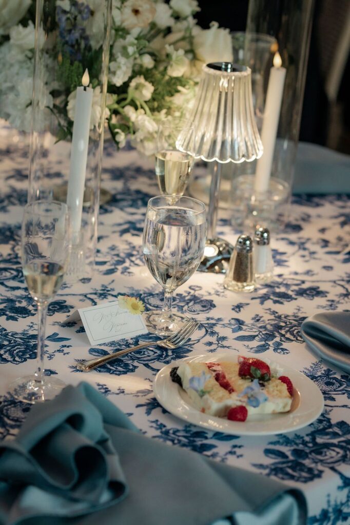 Deer Zink Pavilion table with name tag and piece of wedding cake.