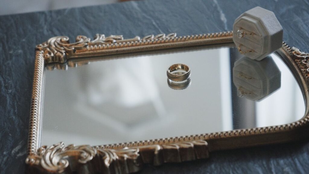 Louisville wedding video screen grab of rings with the dress out of focus.