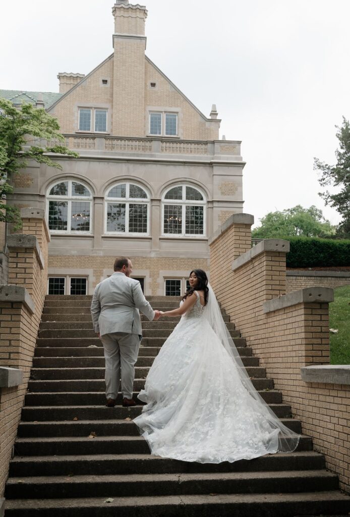 Wedding couple posing on stairs outside
