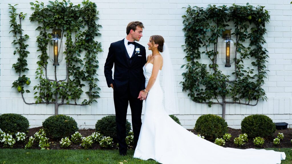Wedding couple standing in front of Ritz Charles in Carmel Indiana.