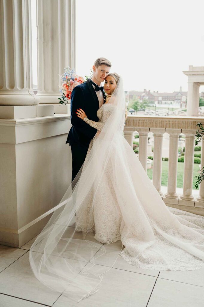 Bride and groom outside on balcony.