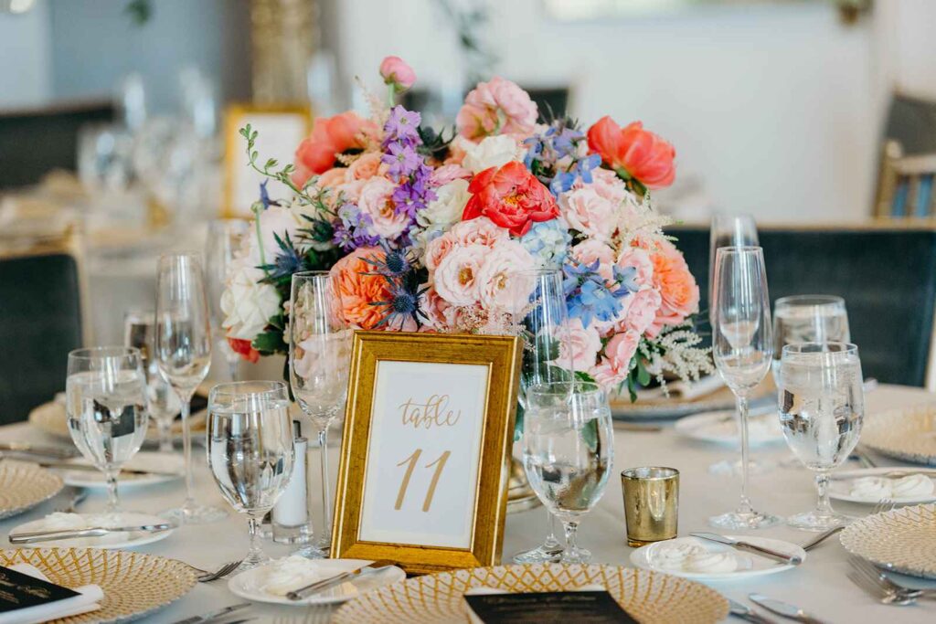 Timeless table top with florals and table number.