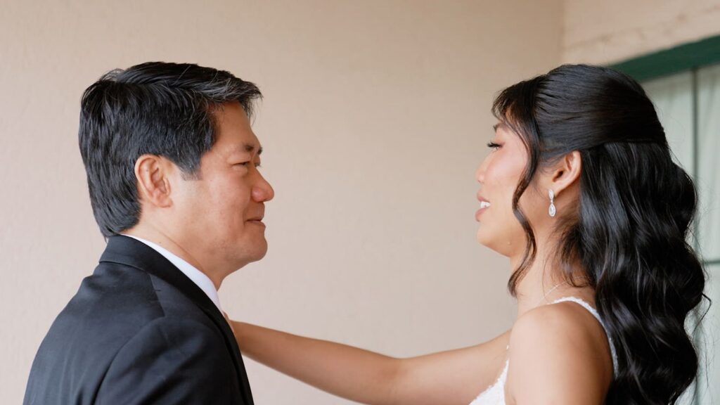 Bride's emotional first look with dad before wedding ceremony.