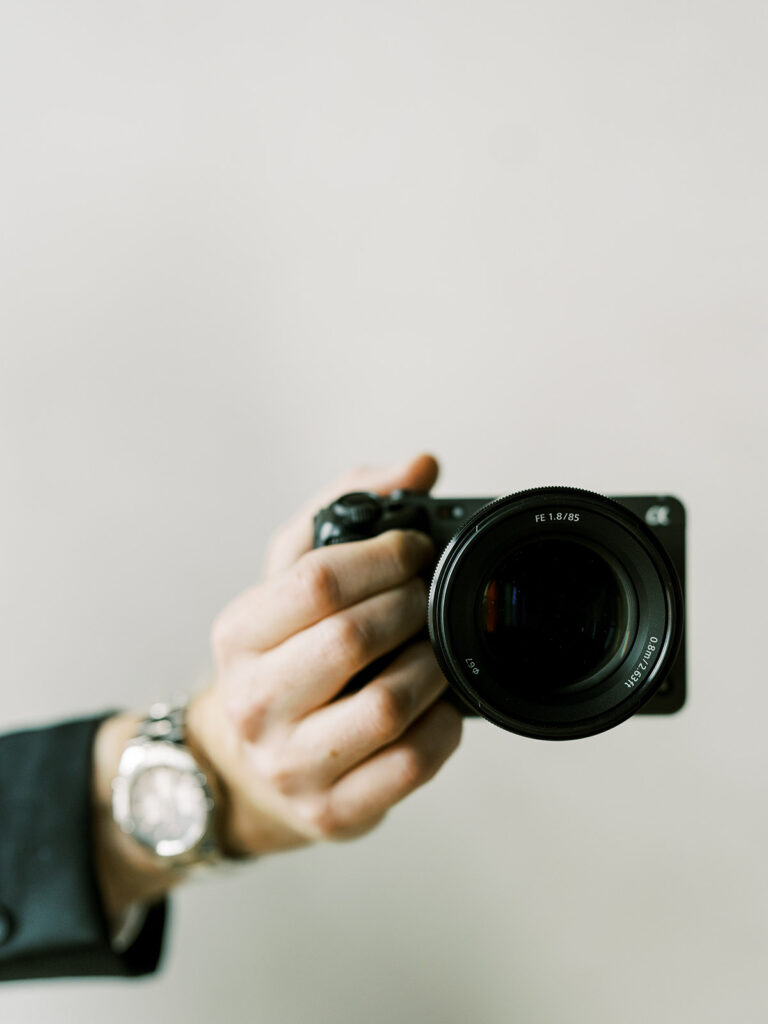 Wedding Videographer camera holding fx3 with 85mm prime lens.