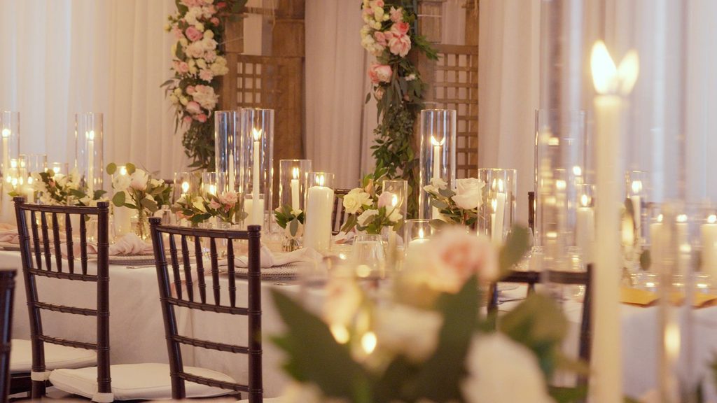 Cinematic Wedding Investment of candles and florals at reception.