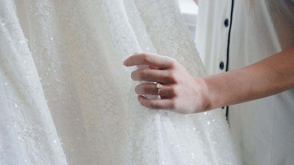 Cinematic Filmmaker captures bride holding her wedding dress.